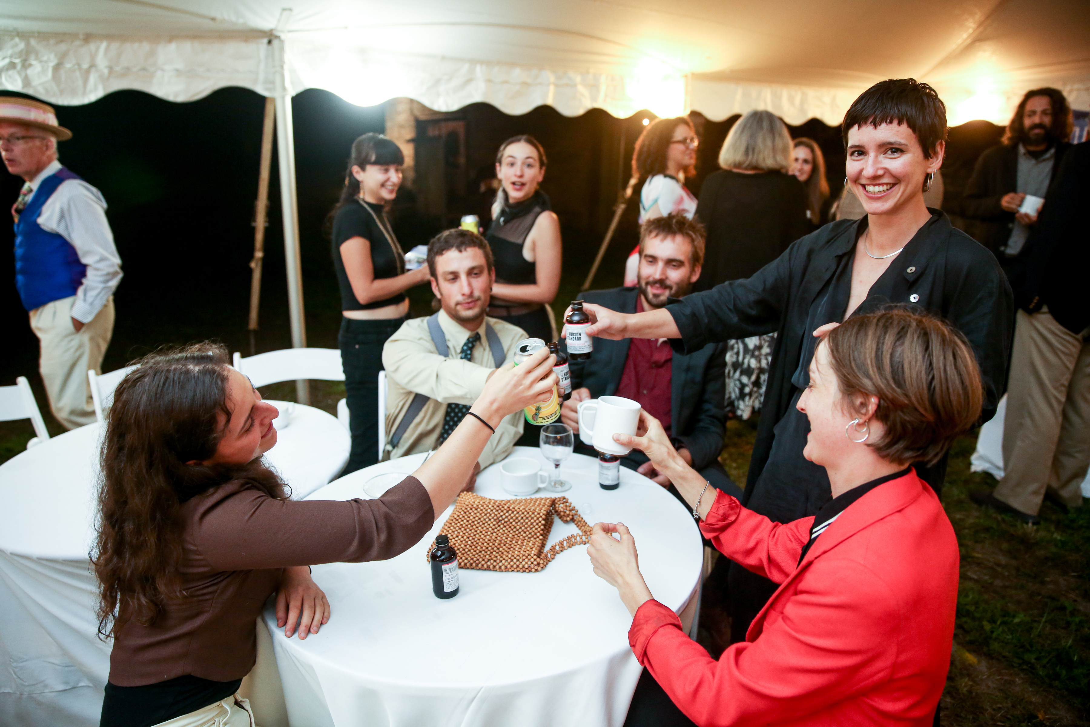 A group of people toasting at a table.