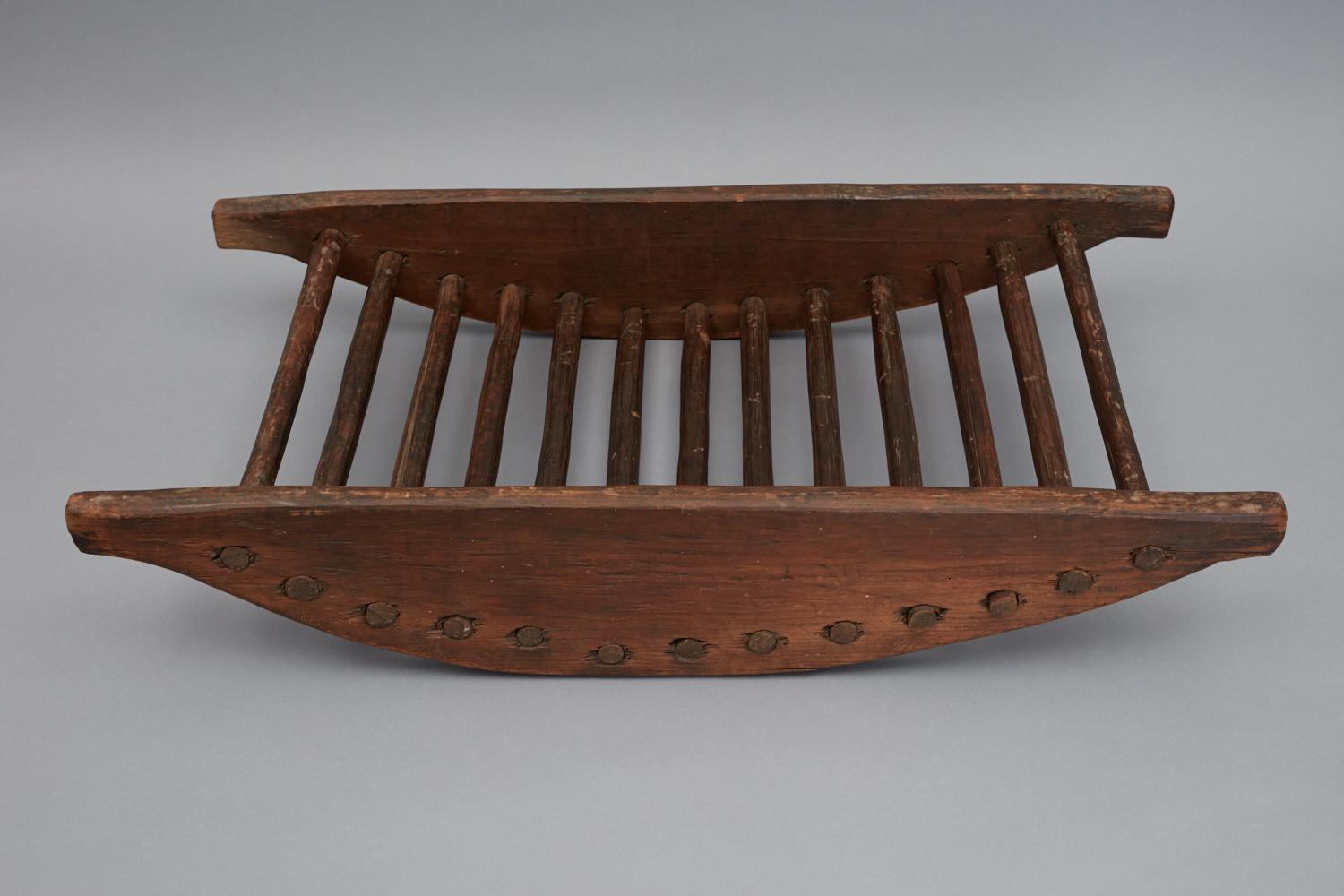 A wooden tray with a wooden handle.