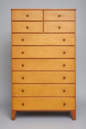 A wooden chest of drawers with many drawers.
