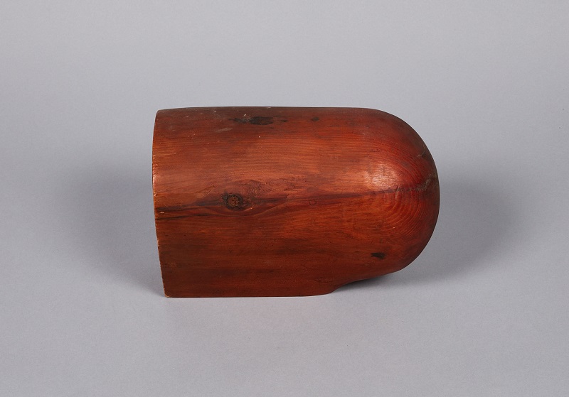 A red wooden bowl on a white background.