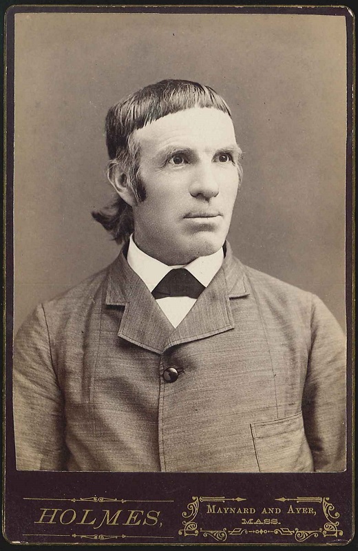 An old photograph of a man with long hair.