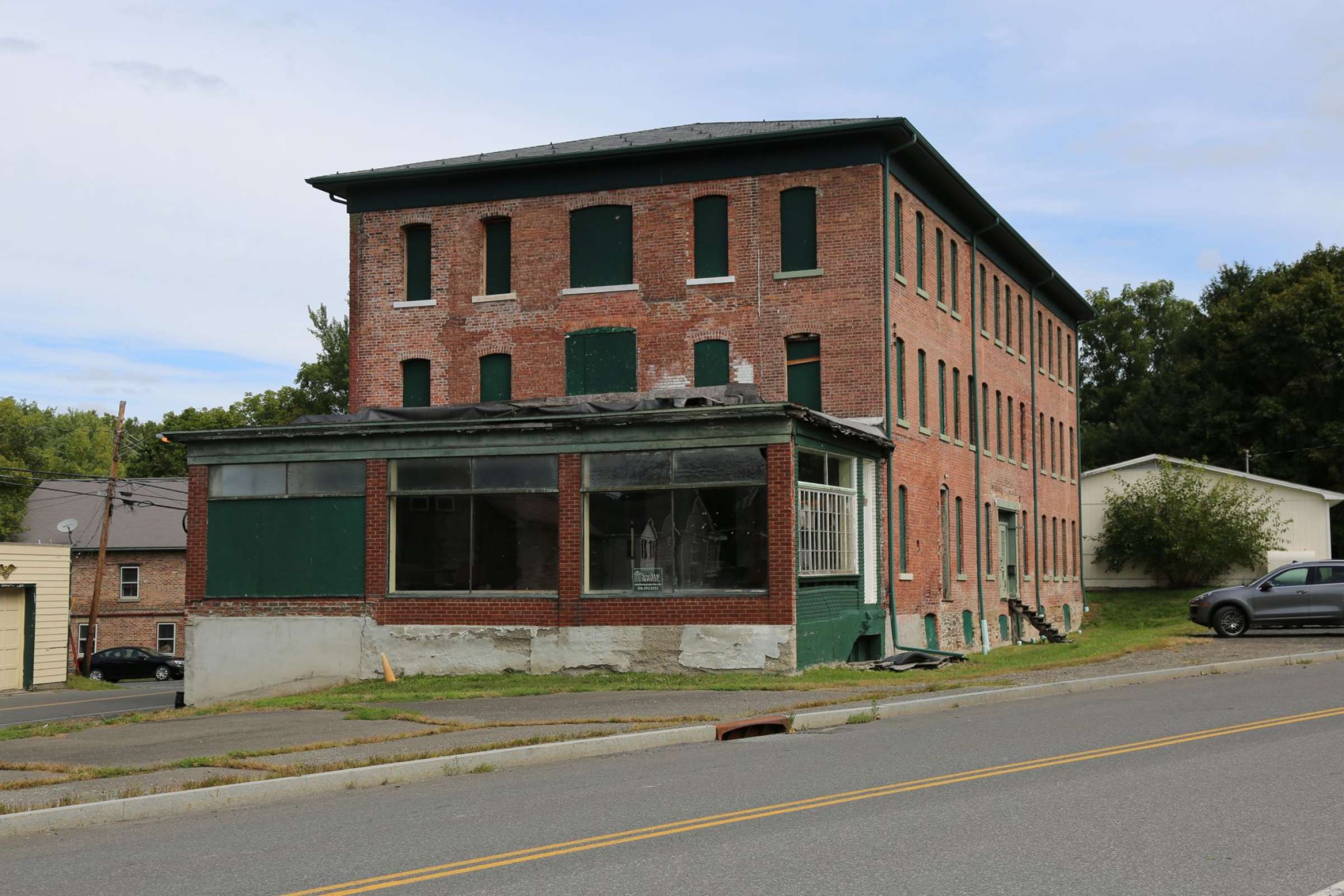 A brick building with green shutters.