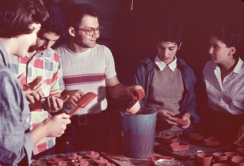 A group of people standing around a table.