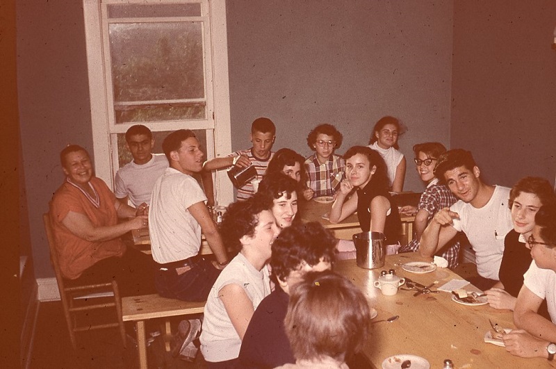A group of people sitting around a table.