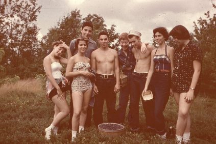 A group of people posing for a picture in a field.