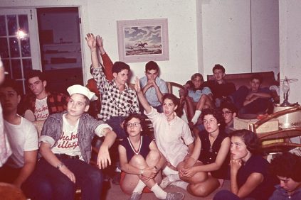 A group of people sitting in a living room.