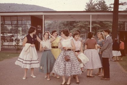 A group of people standing in front of a building.