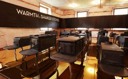 A room with a lot of black chairs in it.