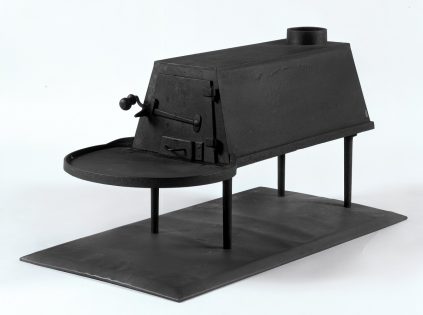 A model of a black oven on a stand.