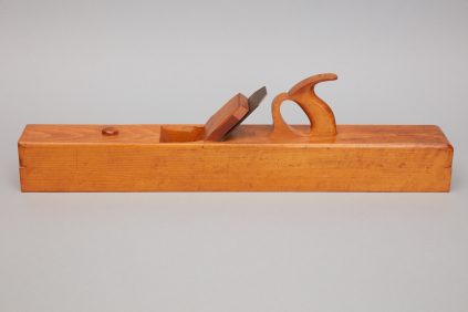 A wooden plane with a wooden handle.