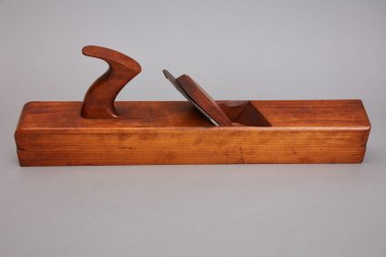 A wooden plane with a handle on it.