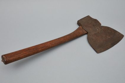 An axe with a wooden handle on a gray background.