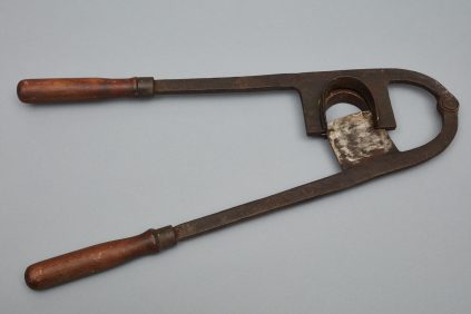A hammer and chisel with a wooden handle.