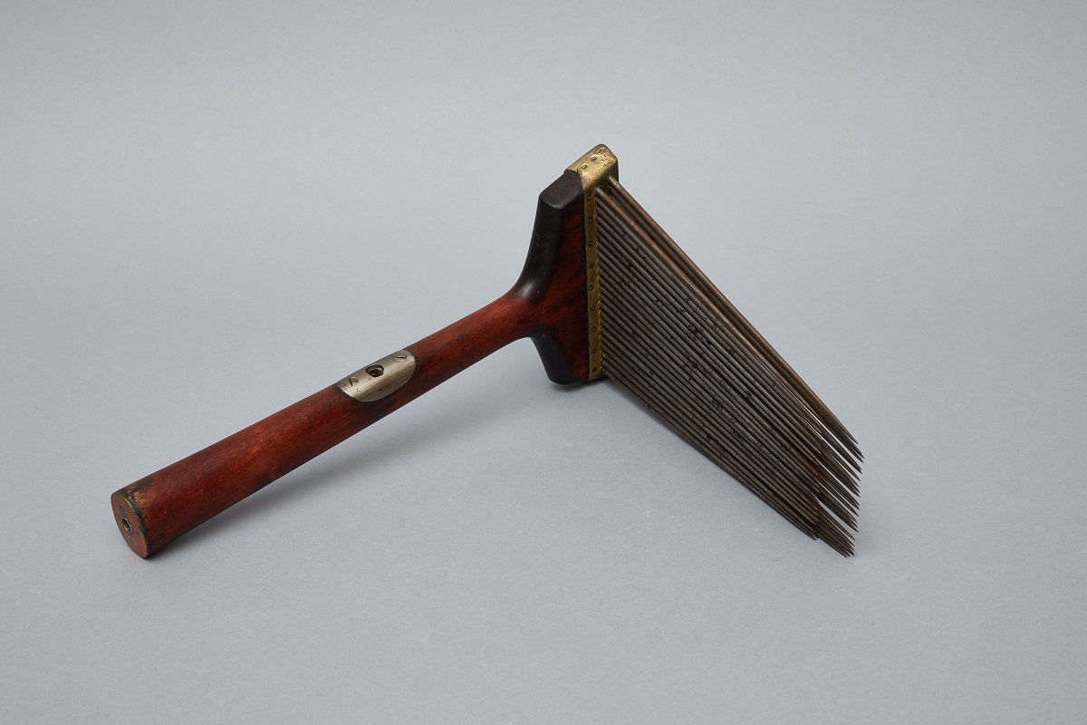 A wooden comb with a wooden handle.