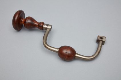 A wooden door handle with a metal handle.