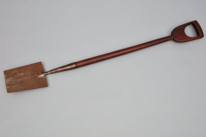 A wooden shovel with a wooden handle.