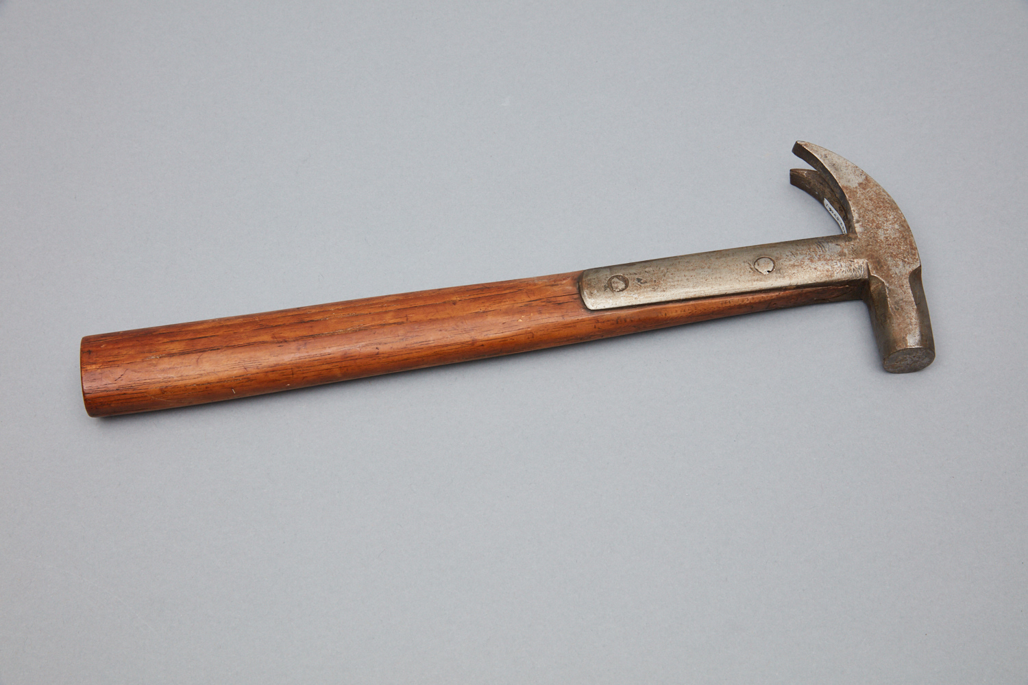 A wooden hammer with a wooden handle.