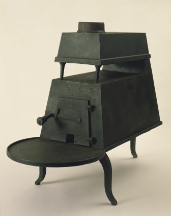 A black stove with a tray on top.