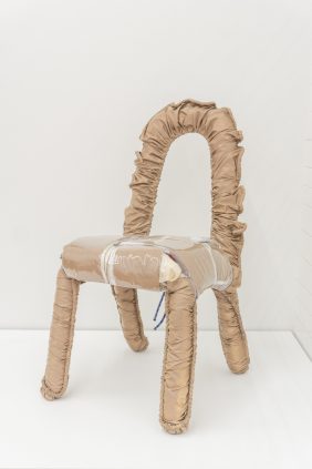 A chair made out of a plastic bag.