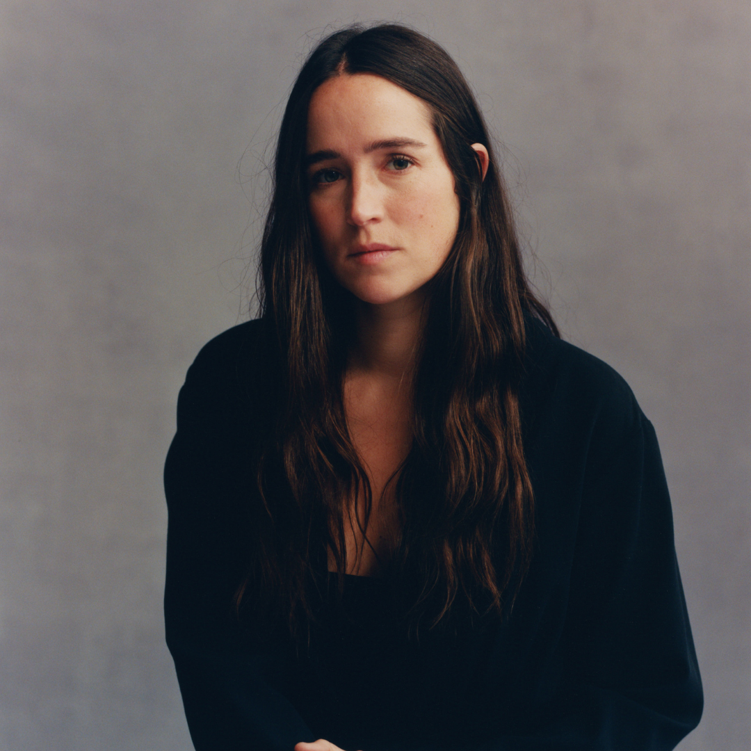 A woman with long hair posing for a photo.