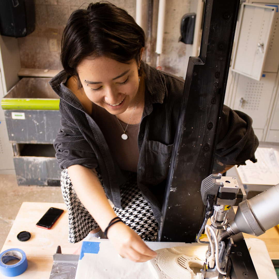 A woman working on a sewing machine.