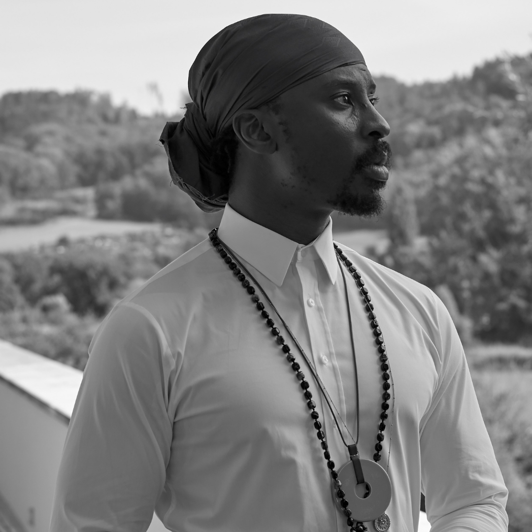 A black and white photo of a man wearing a turban.