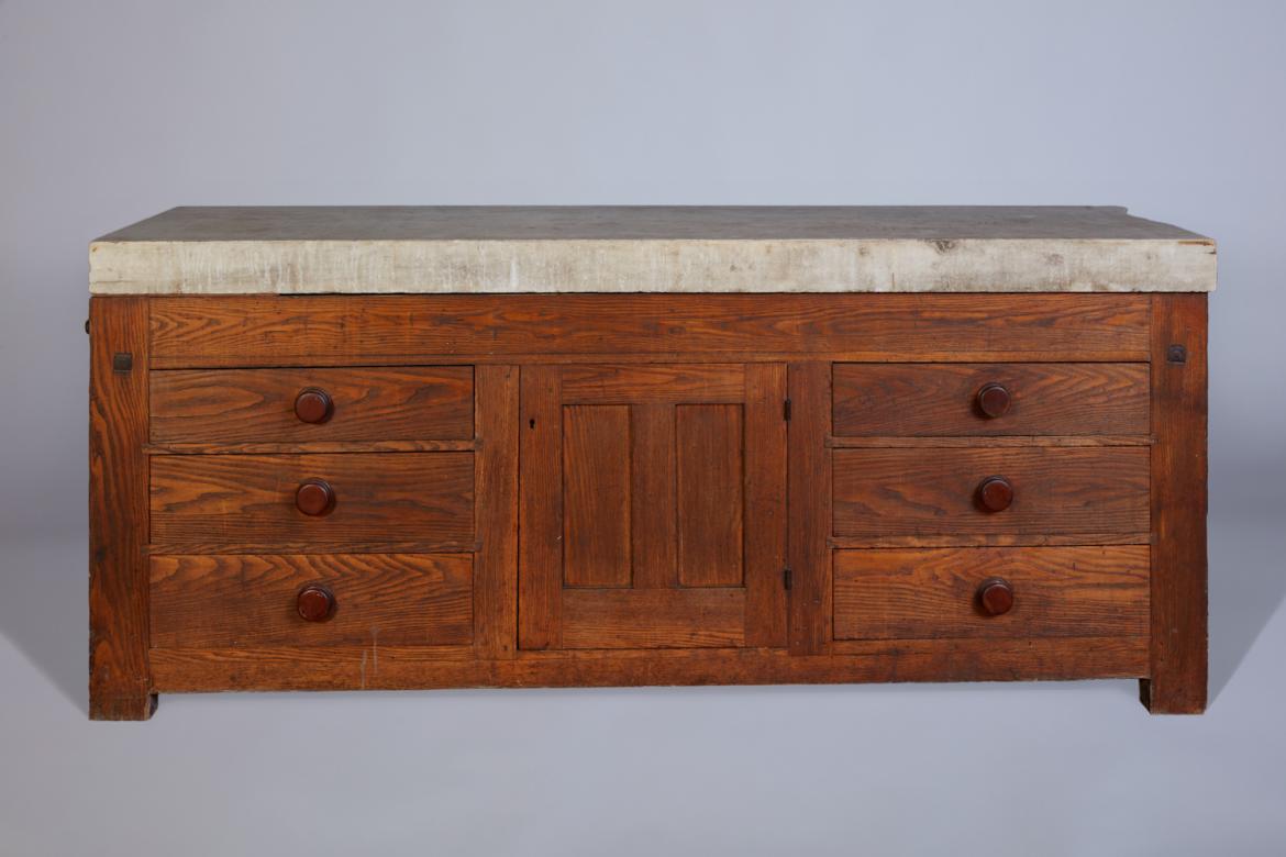 An old wooden dresser with a marble top.