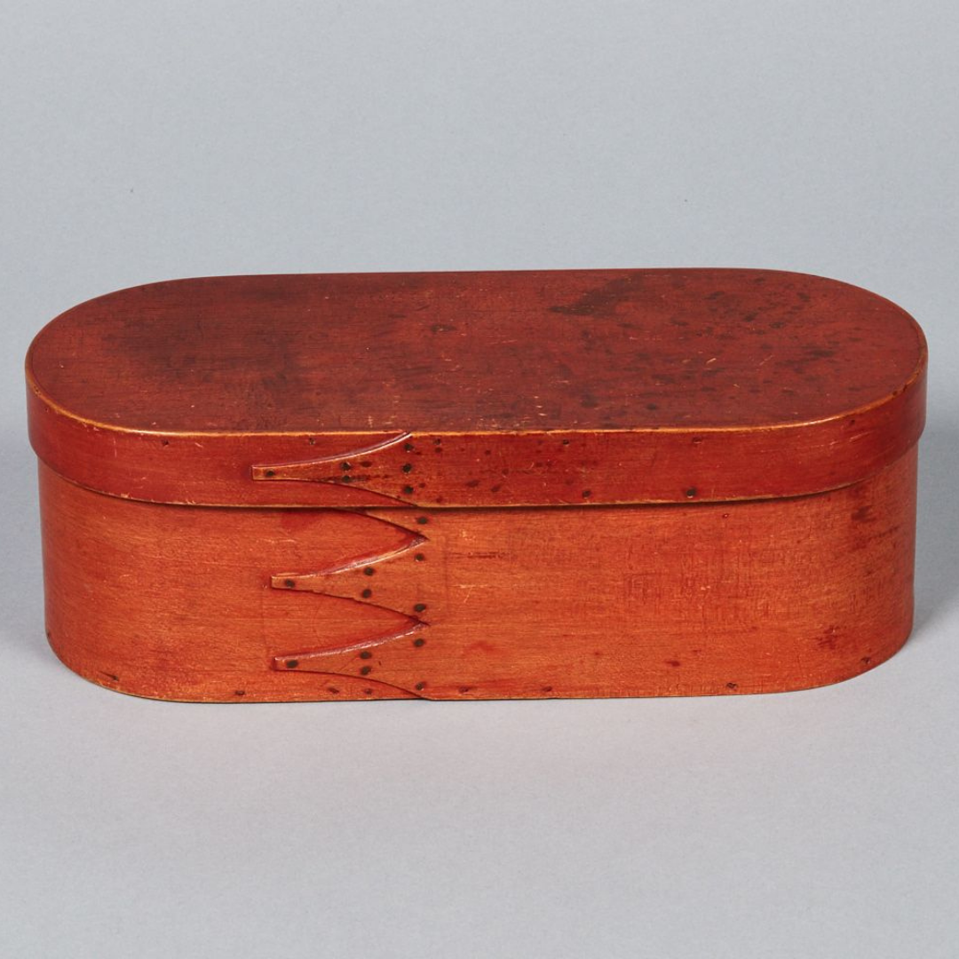 A red wooden box with a lid.