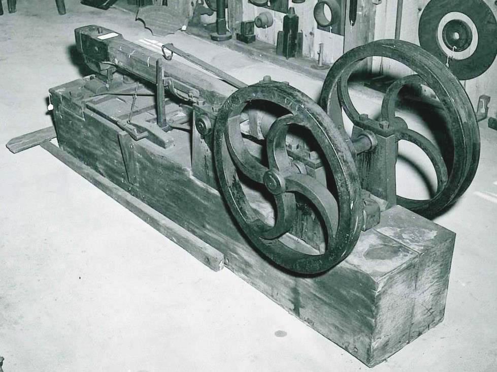 An old black and white photo of a wooden machine.