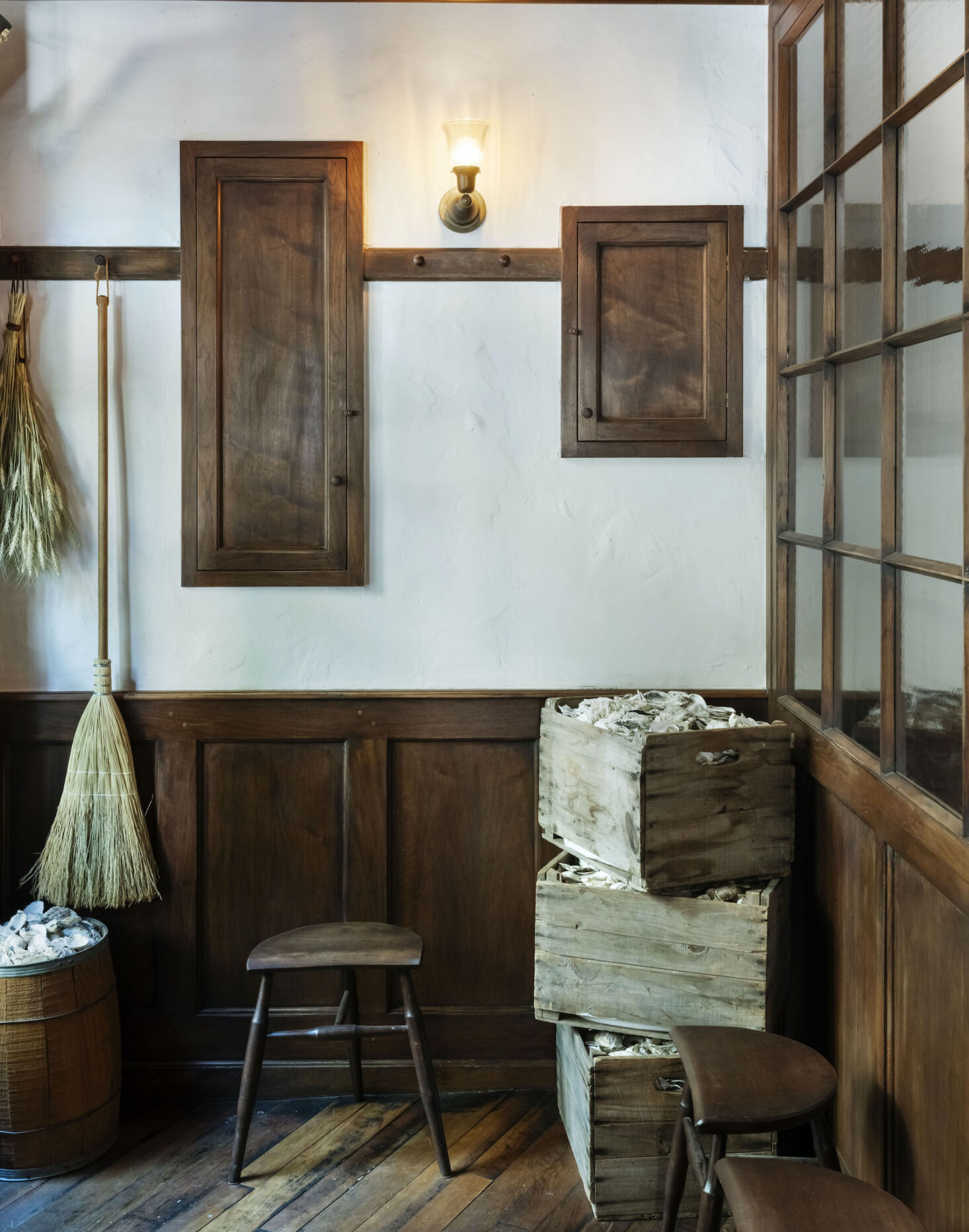 A room with wooden furniture and a broom.