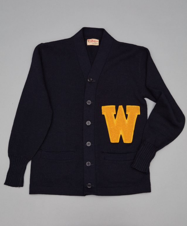 A navy cardigan with the letter w on it.