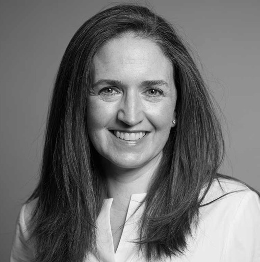 A black and white photo of a woman smiling.