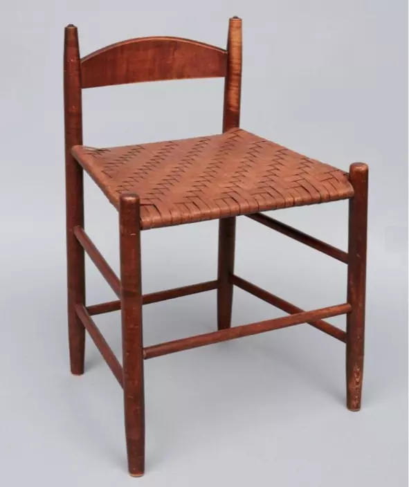 A wooden chair with a woven seat.