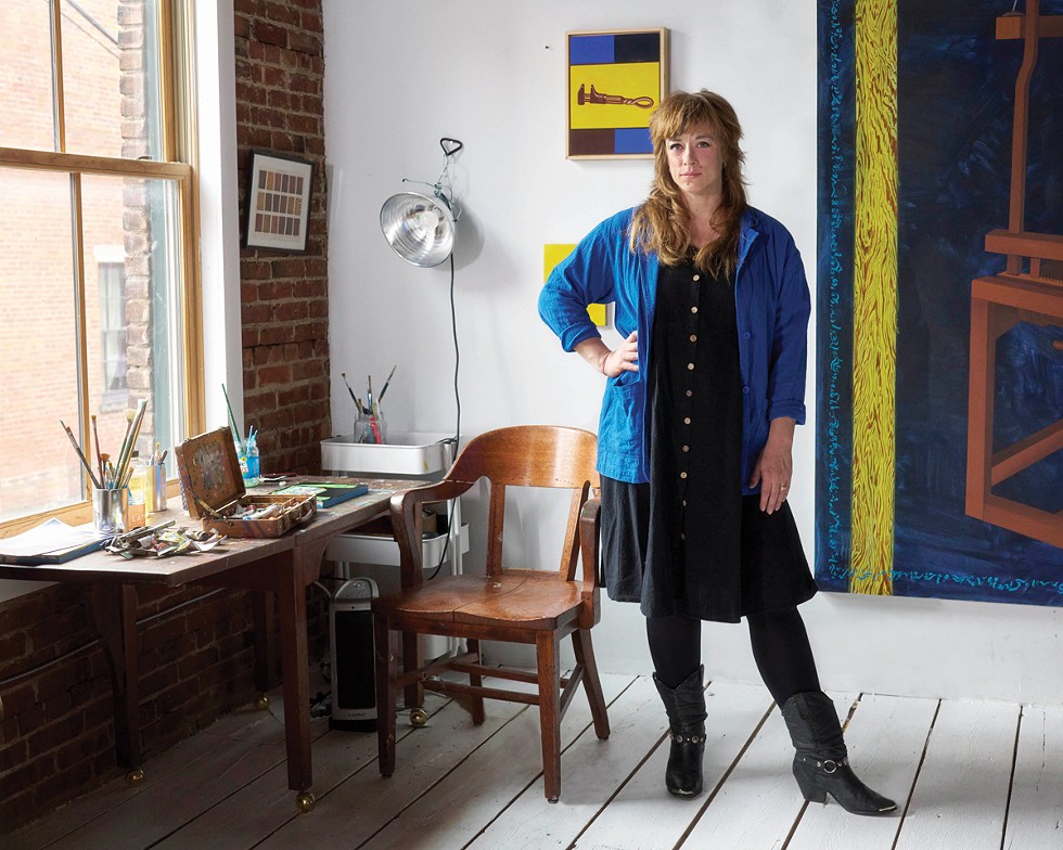 Caitlin MacBride stands in her painting studio