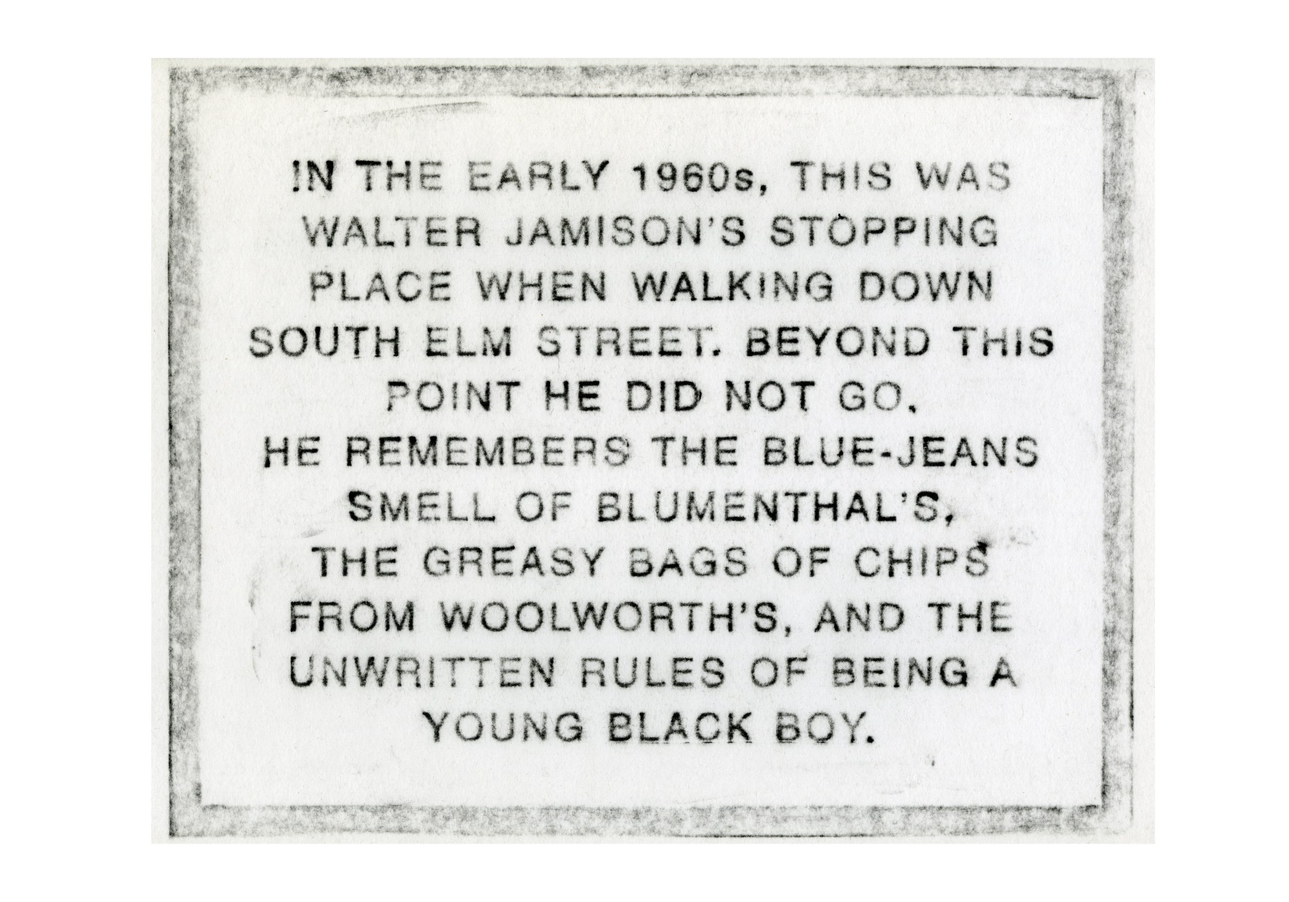 Plaque with a historical description from walter jamison about his experiences walking down south elm street in the early 1960s.